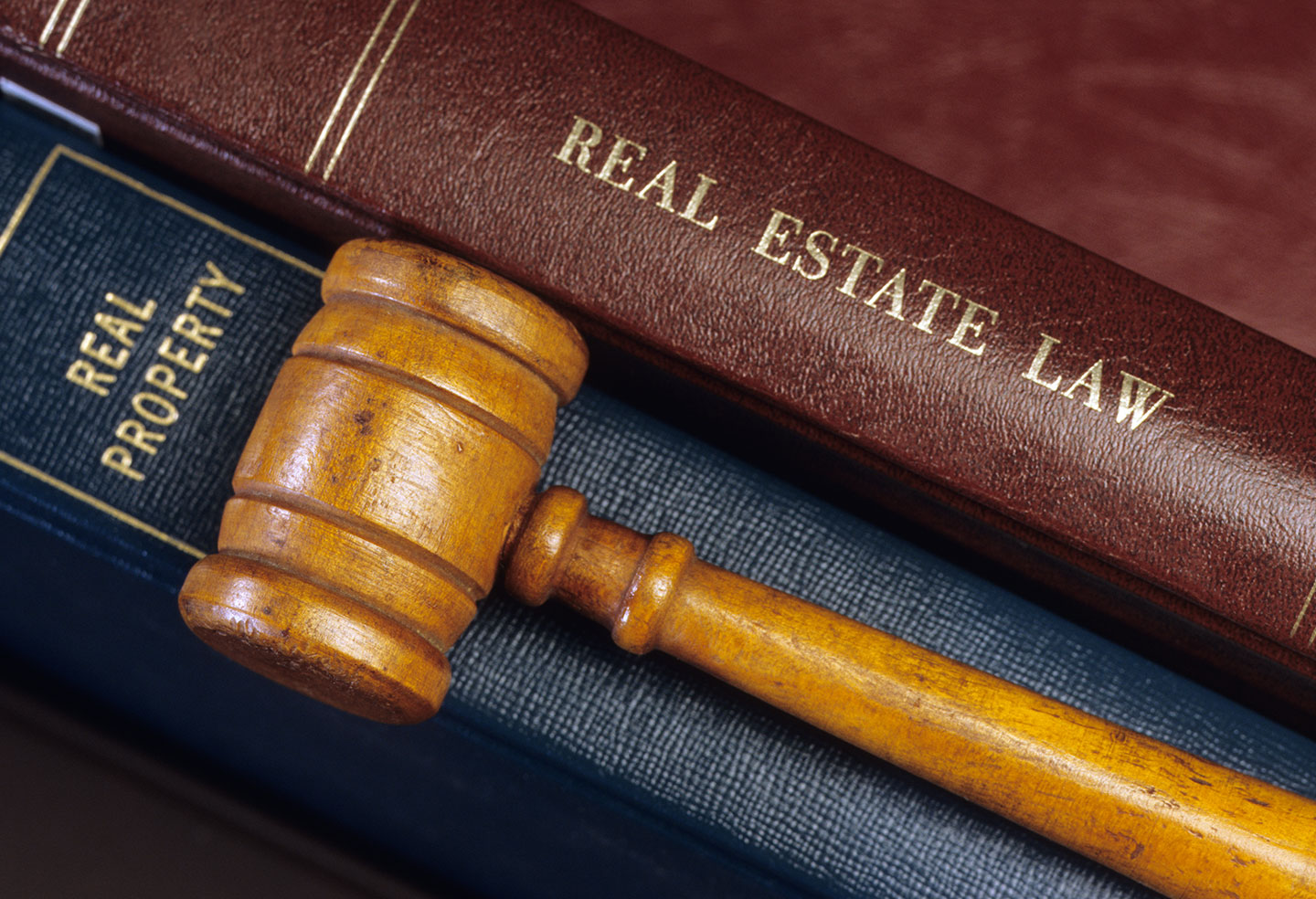 Gavel laying across BC Residential Tenancy and Real Estate Law Books