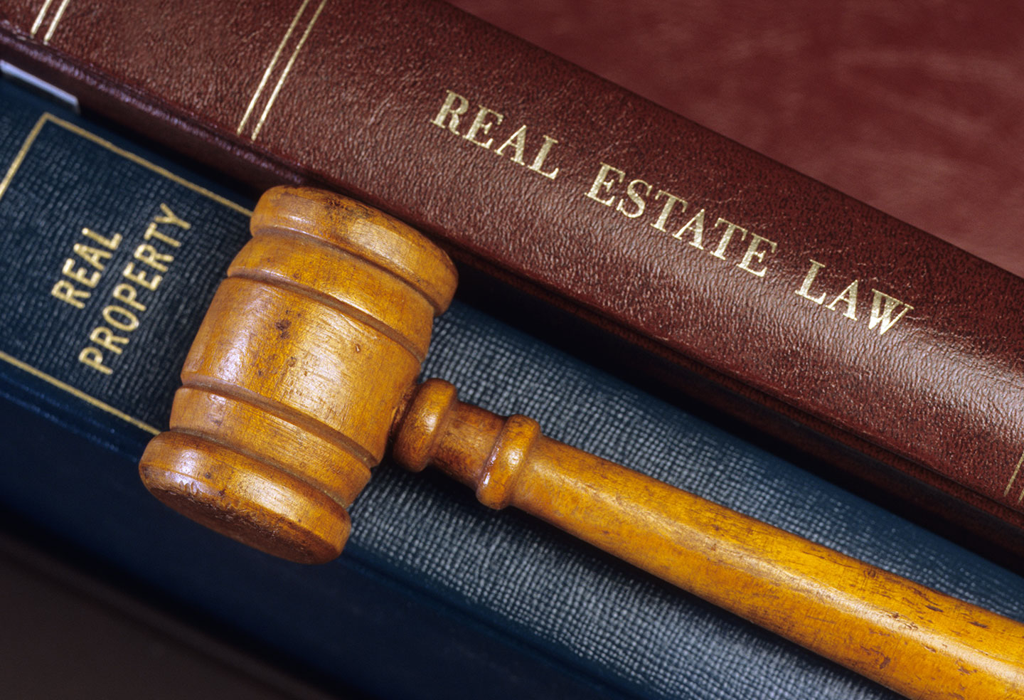 BC Residential Tenancy Act Gavel laying across BC Residential Tenancy and Real Estate Law Books